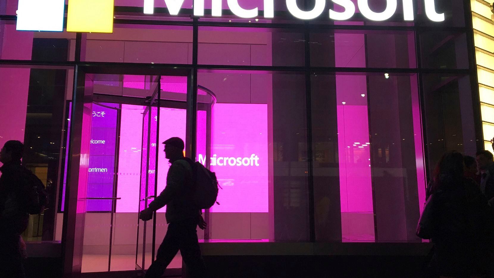 People walk past a Microsoft office in New York.