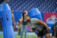Auburn defensive lineman Justin Rogers runs a drill at the NFL football scouting combine,...