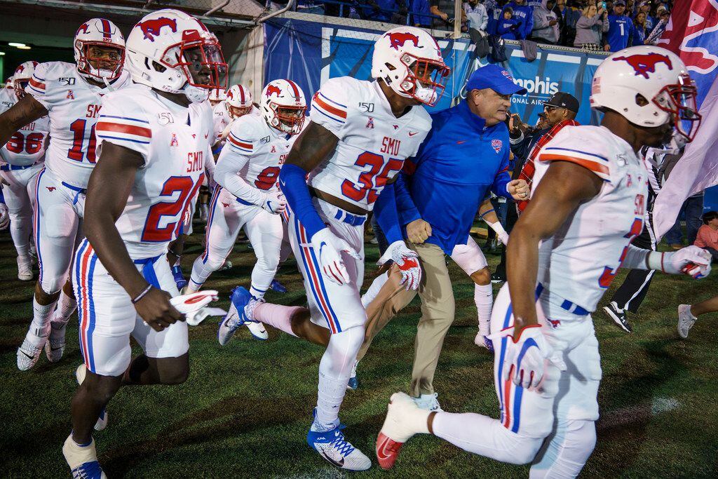 SMU head coach Sonny Dykes takes the field with his team before an NCAA football game...