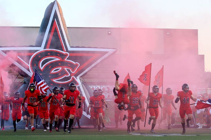 The Coppell Cowboys enter the field to face Lewisville in a high school football game on...