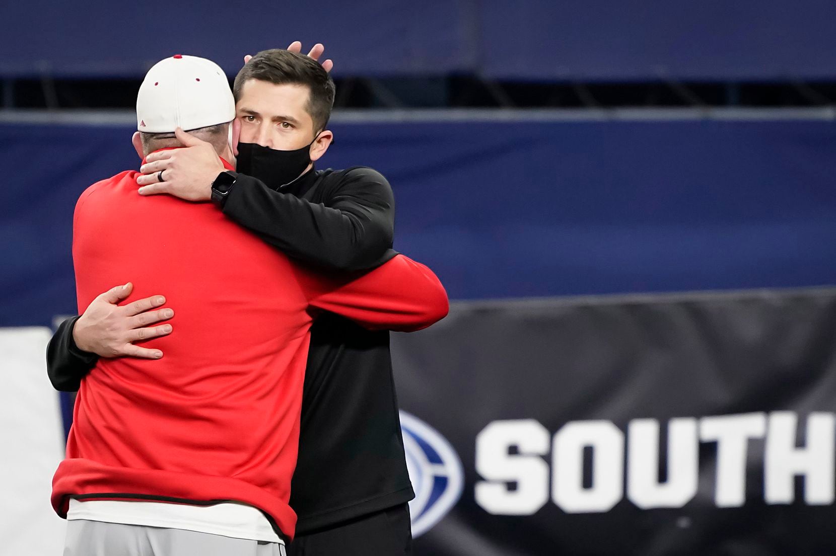 Southlake Carroll head coach Riley Dodge (facing) hugs his father, Austin Westlake head coach Todd Dodge, before the two faced in the Class 6A Division I state football championship game at AT&T Stadium on Saturday, Jan. 16, 2021, in Arlington, Texas.