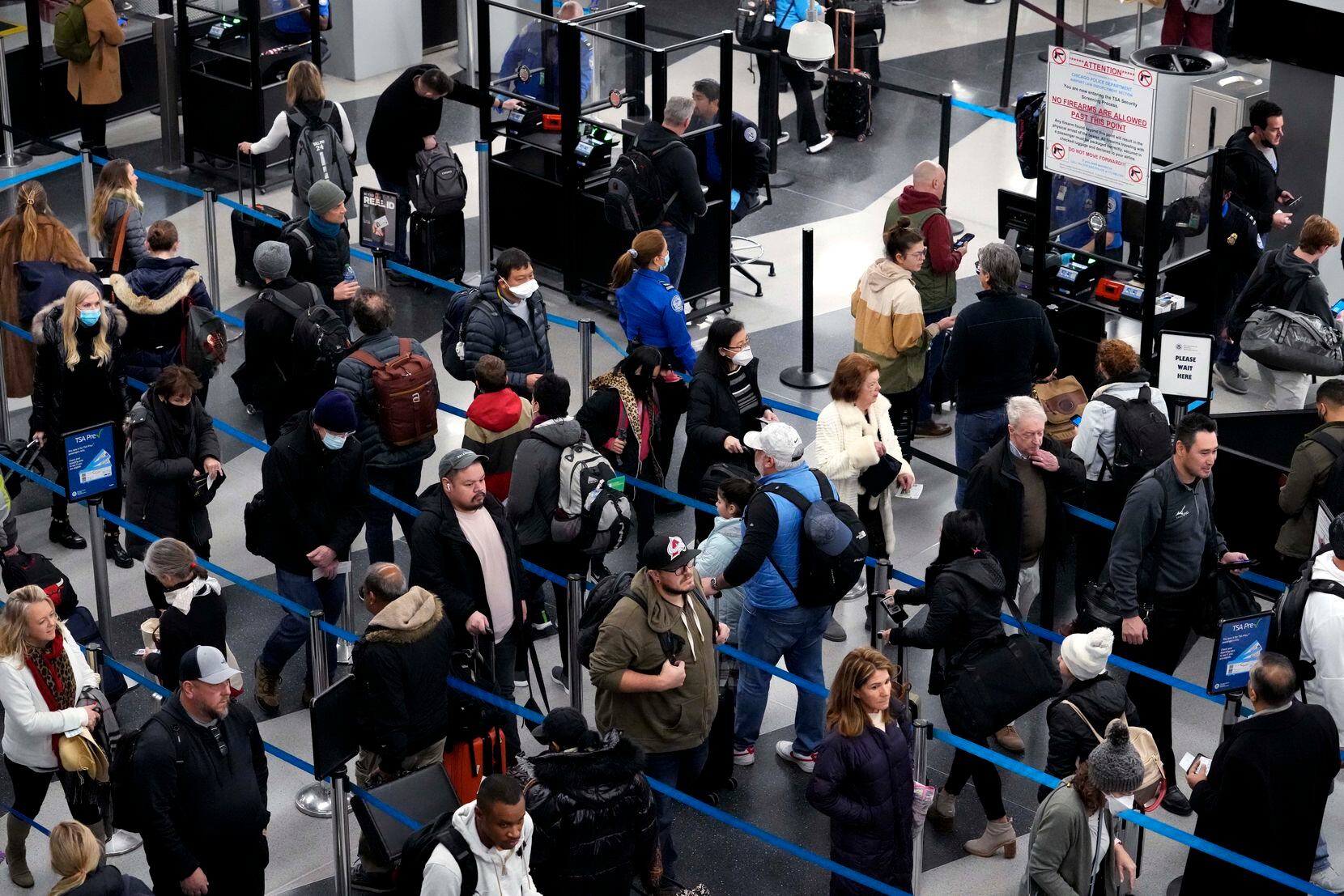 Travelers wait to pass through a security checkpoint at O'Hare International Airport in Chicago.