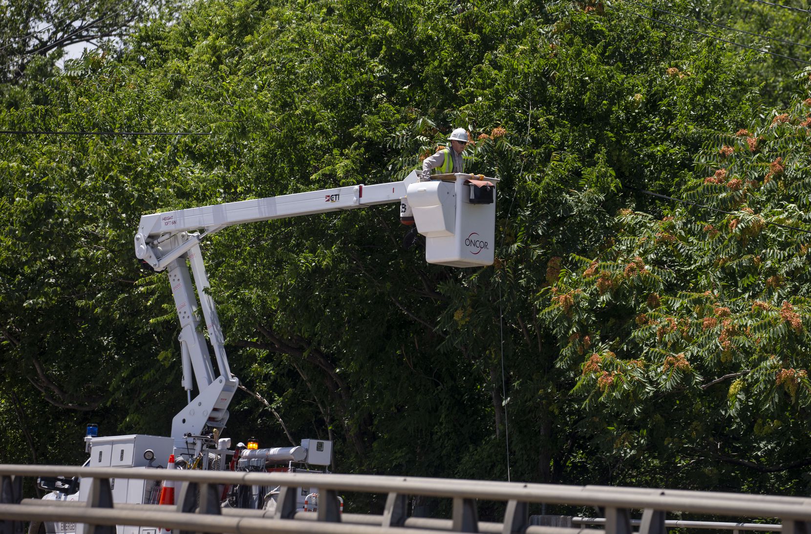 Oncor workers repaired power lines on Samuell Boulevard in Dallas on Monday, June 10, 2019....