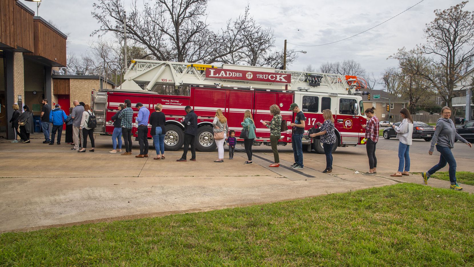 A long line of voters wait to cast their ballots in the primary election after 5 p.m. at Dallas Fire Station No. 17 in the Lakewood Heights neighborhood of Dallas on Tuesday, March 3, 2020.
