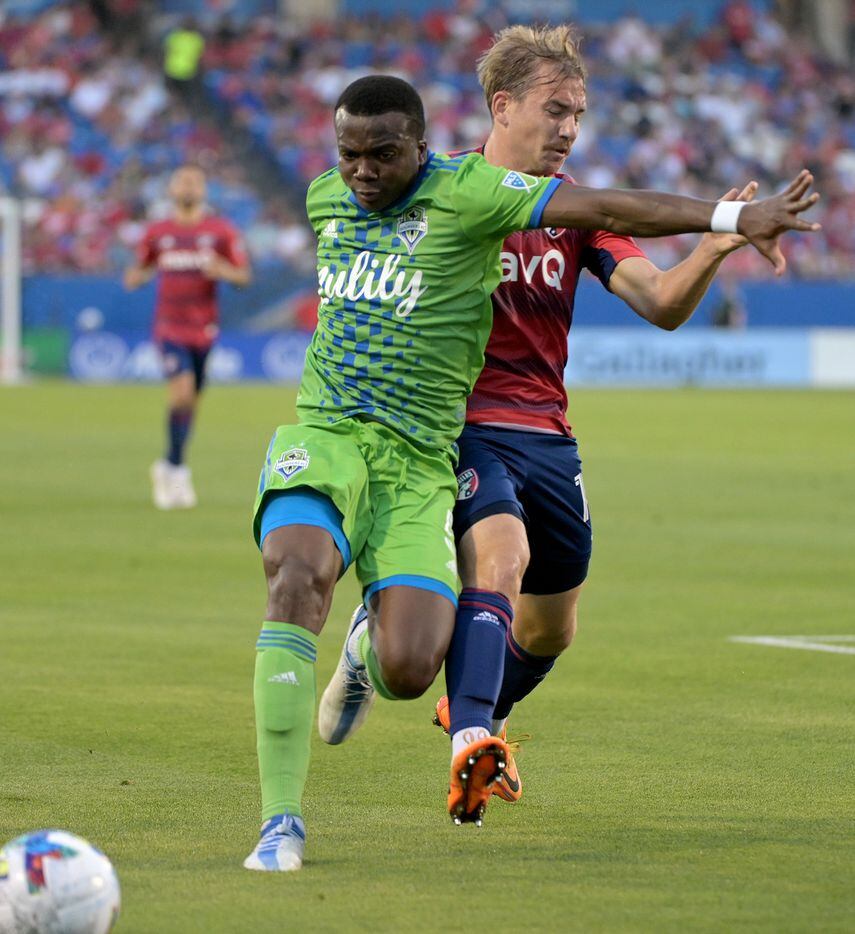 Seattle Sounders defender Nouhou Tolo (5) and FC Dallas midfielder Paxton Pomykal (19) go...