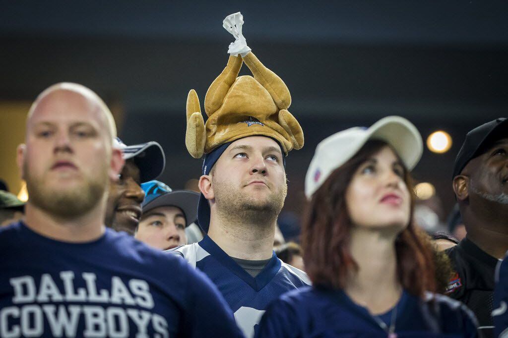 A Dallas Cowboys fan wears a turkey hat as he watches during the first quarter of an NFL...