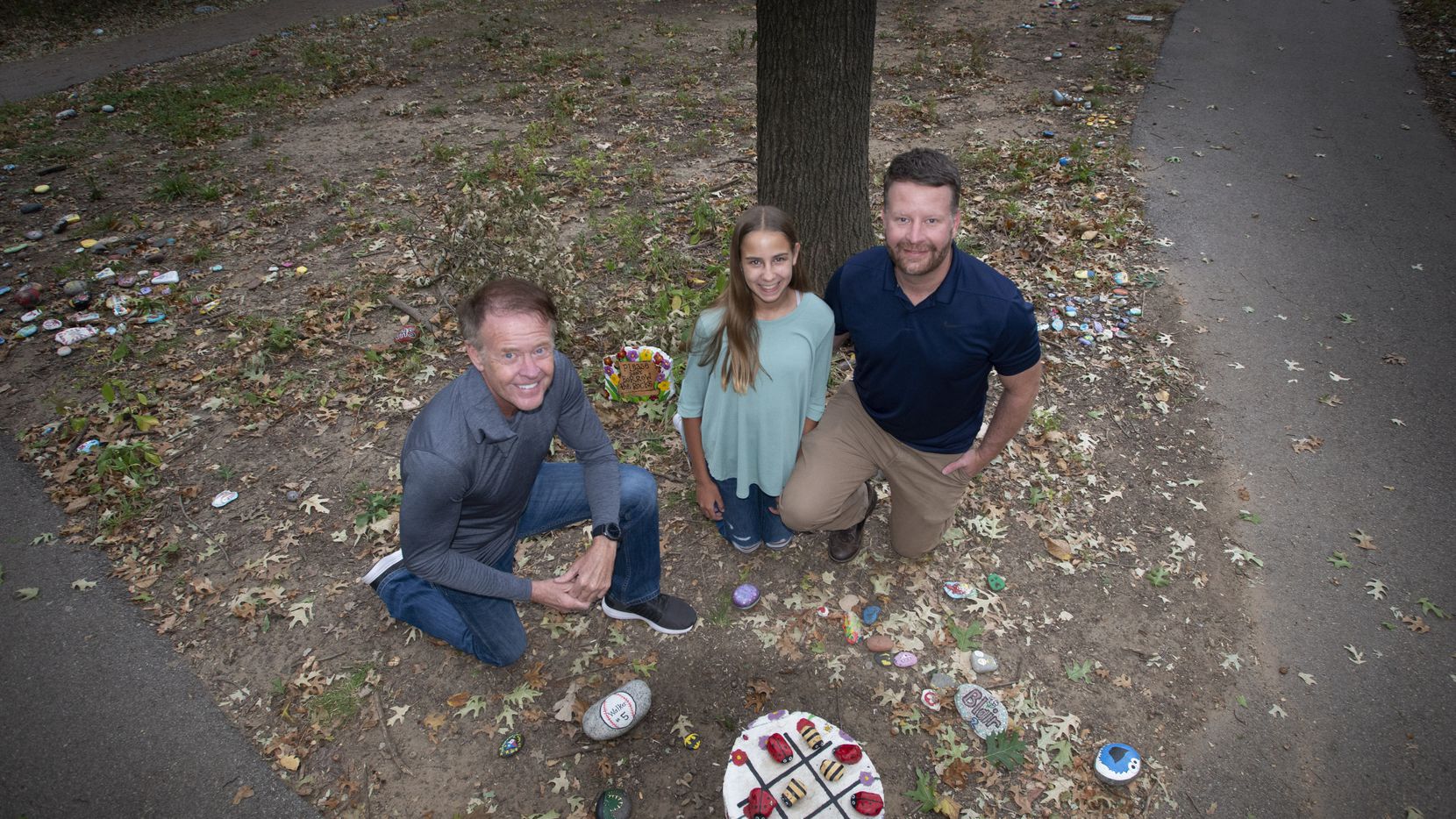 Ron Olsen, left, Sophia Penny and her father Chris Penny on the rock art trail at...
