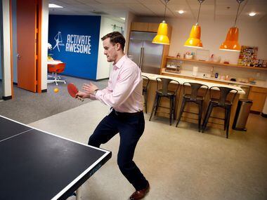 Franchisee operations manager Jeff Bales plays table tennis at the headquarters in Bedford....