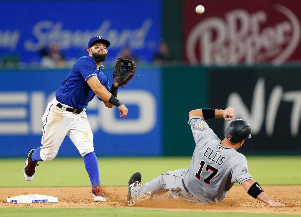 Texas Rangers second baseman Rougned Odor (12) turns the front end of a double play getting...