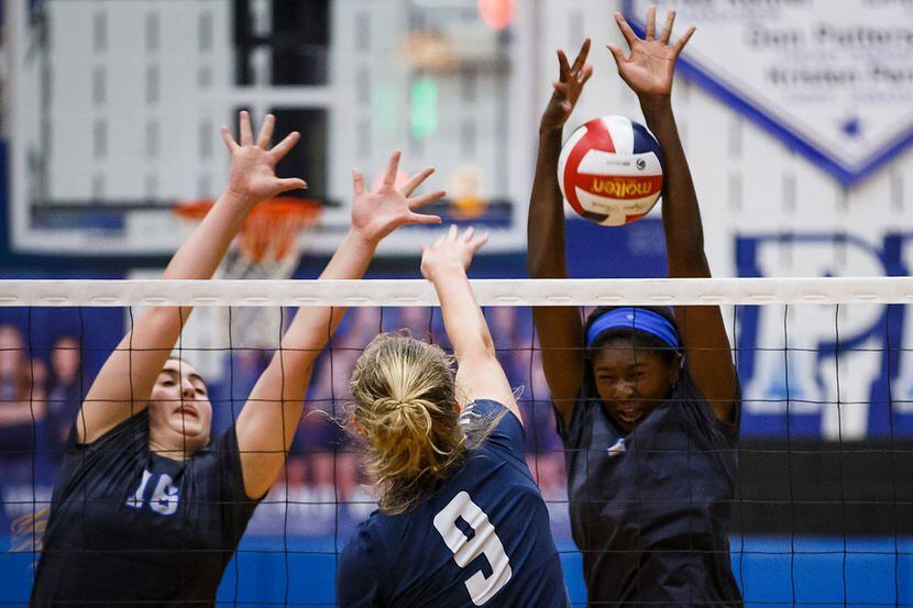 Plano West's Iman Ndiaye (right) and Lauren Blomquist (16) go up for a block against...