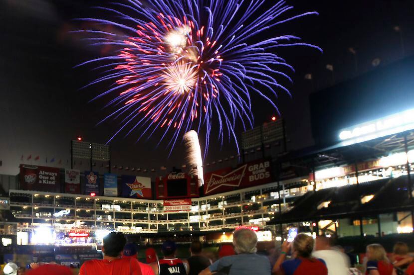 Texas Rangers players' families watch the post-game fireworks show from the field at Globe...