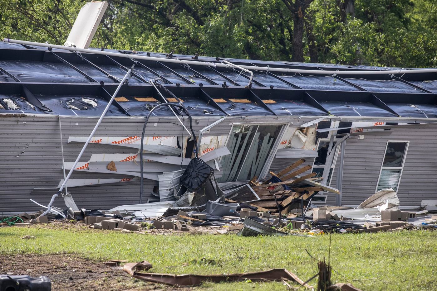 A mobile home was turned upside down in the aftermath of a Monday night tornado that touched down just south of Waxahachie, Texas, on Tuesday, May 4, 2021. (Lynda M. González/The Dallas Morning News)