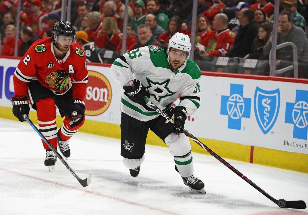 CHICAGO, ILLINOIS - FEBRUARY 24: Mats Zuccarello #36 of the Dallas Stars passes under pressure from Duncan Keith #2 of the Chicago Blackhawks at the United Center on February 24, 2019 in Chicago, Illinois. (Photo by Jonathan Daniel/Getty Images)