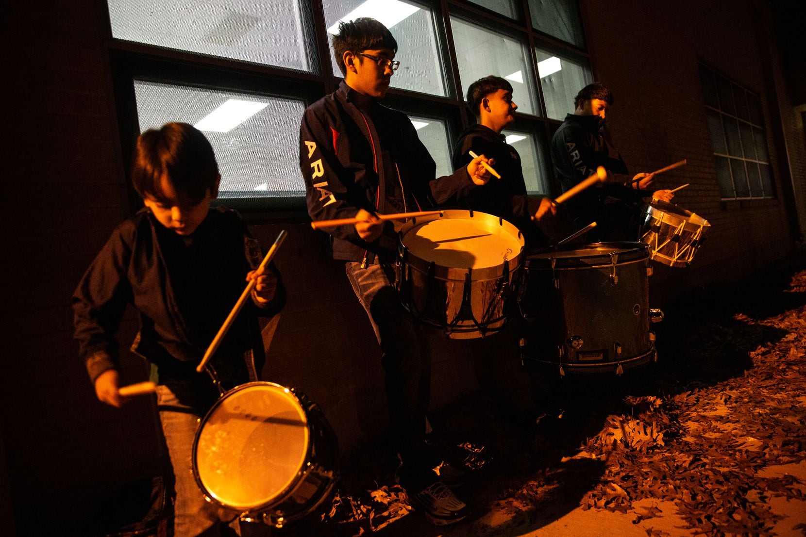 Brothers (from left) Christopher de la Sancha, 7, and Alexander Flores, 15, play the drums with brothers Arnulfo Diaz Jr., 15, and Abraham Diaz, 21, to keep rhythm for Danza Chichimeca San Miguel de Arcángel members.