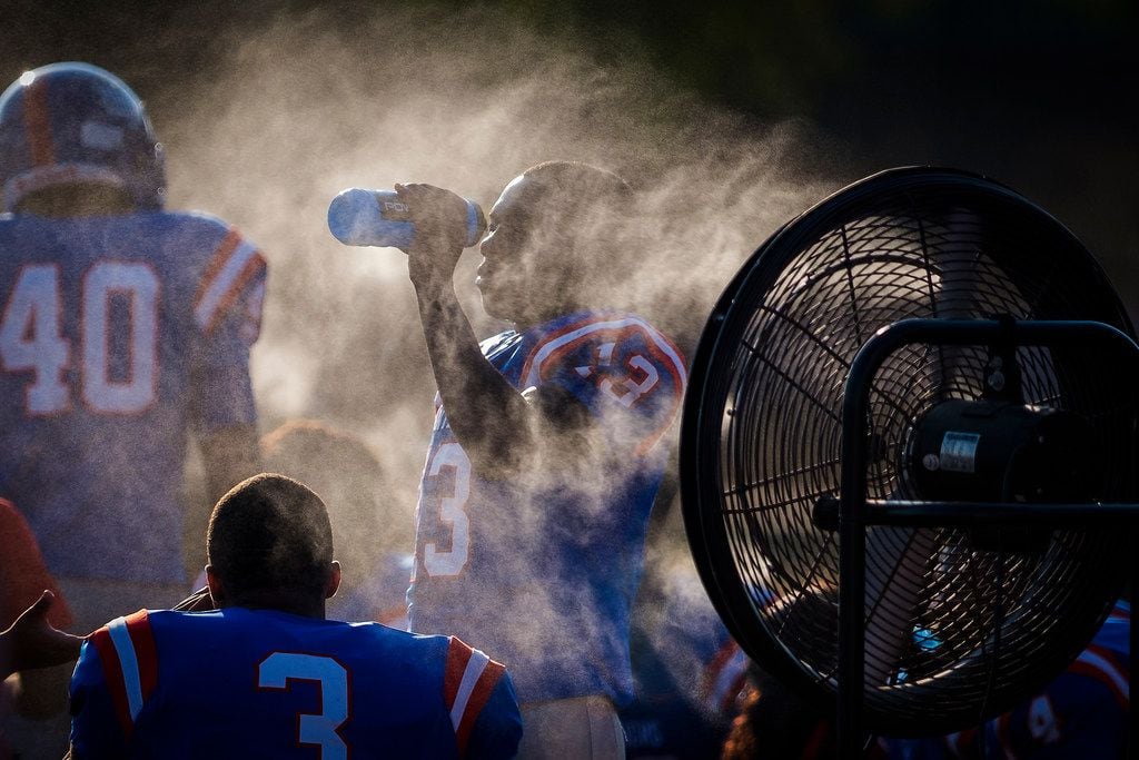 Duncanville wide receiver Roderick Daniels (13) cools off on the sidelines during the first...