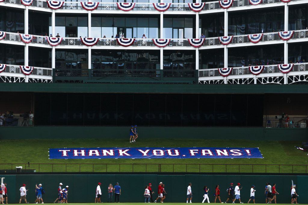 Fans enter the stadium before a MLB game between Texas Rangers and New York Yankees on...