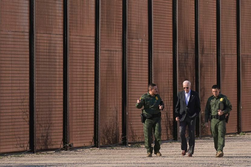 FILE - President Joe Biden walks with U.S. Border Patrol agents along a stretch of the...