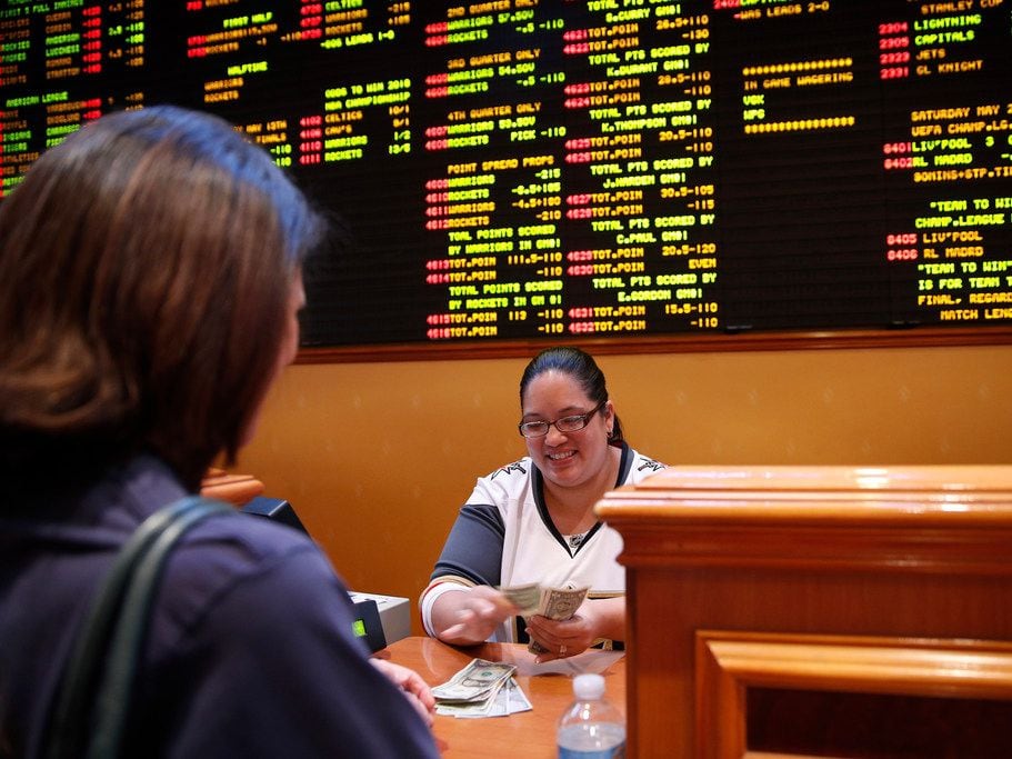 Crystal Kalahiki pays out a bet in the sports book at the South Point hotel-casino, Monday,...