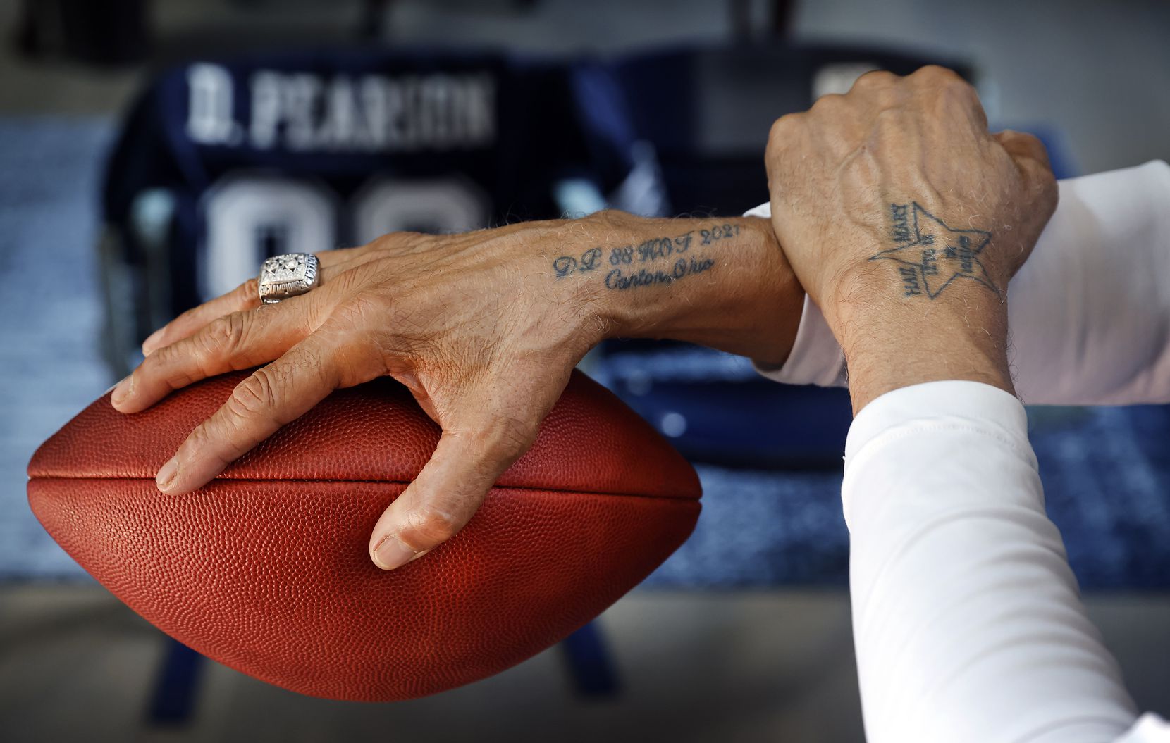 Pro Football Hall of Fame inductee Drew Pearson shows off his new tattoos. On his right arm...