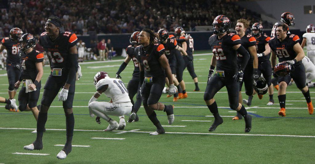 Aledo Bearcats players storm the field as Ennis Lions players including Azain Brown (10) react in shock following the 43-36 overtime win by Aledo to advance. The two teams played their Class 5A Division ll Regional final playoff football game at Frisco Center at The Star in Frisco on December 6, 2019. (Steve Hamm/ Special Contributor)