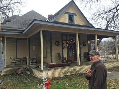 A photo taken in December 2017 shows John Grindle in front of the 114-year-old house at 2426...