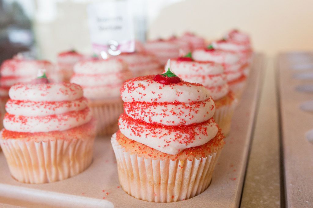 Strawberry Shortcake cupcakes sit in the window at Gigi's Cupcakes. The parent company just...