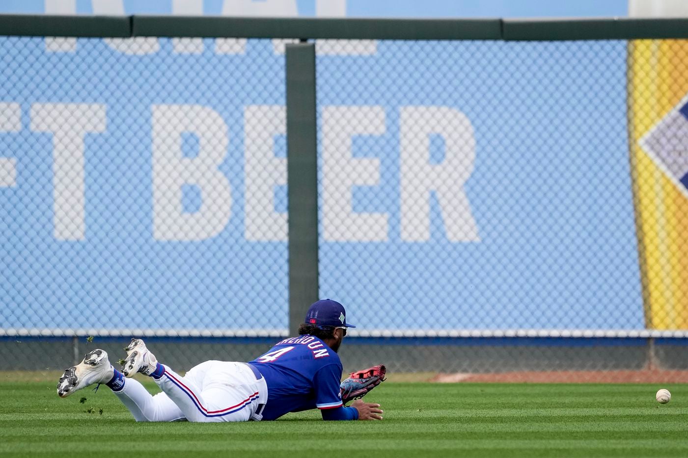 The ball gets away from Texas Rangers outfielder Willie Calhoun on a single by the Milwaukee...