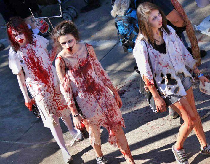 Three women dressed as zombies walk through Deep Ellum during Zombie Walk.