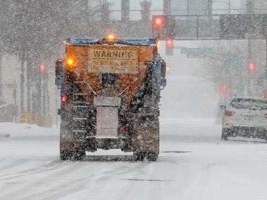 A sanding truck drives through a snow covered downtown Fort Worth on Thursday, Feb. 3, 2022.