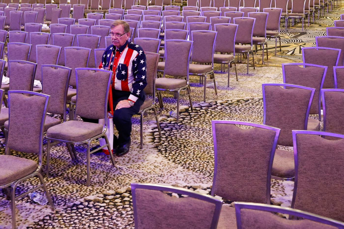 Attendee T.E Sumner wearing an attire of the U.S National flag sits by himself after the...