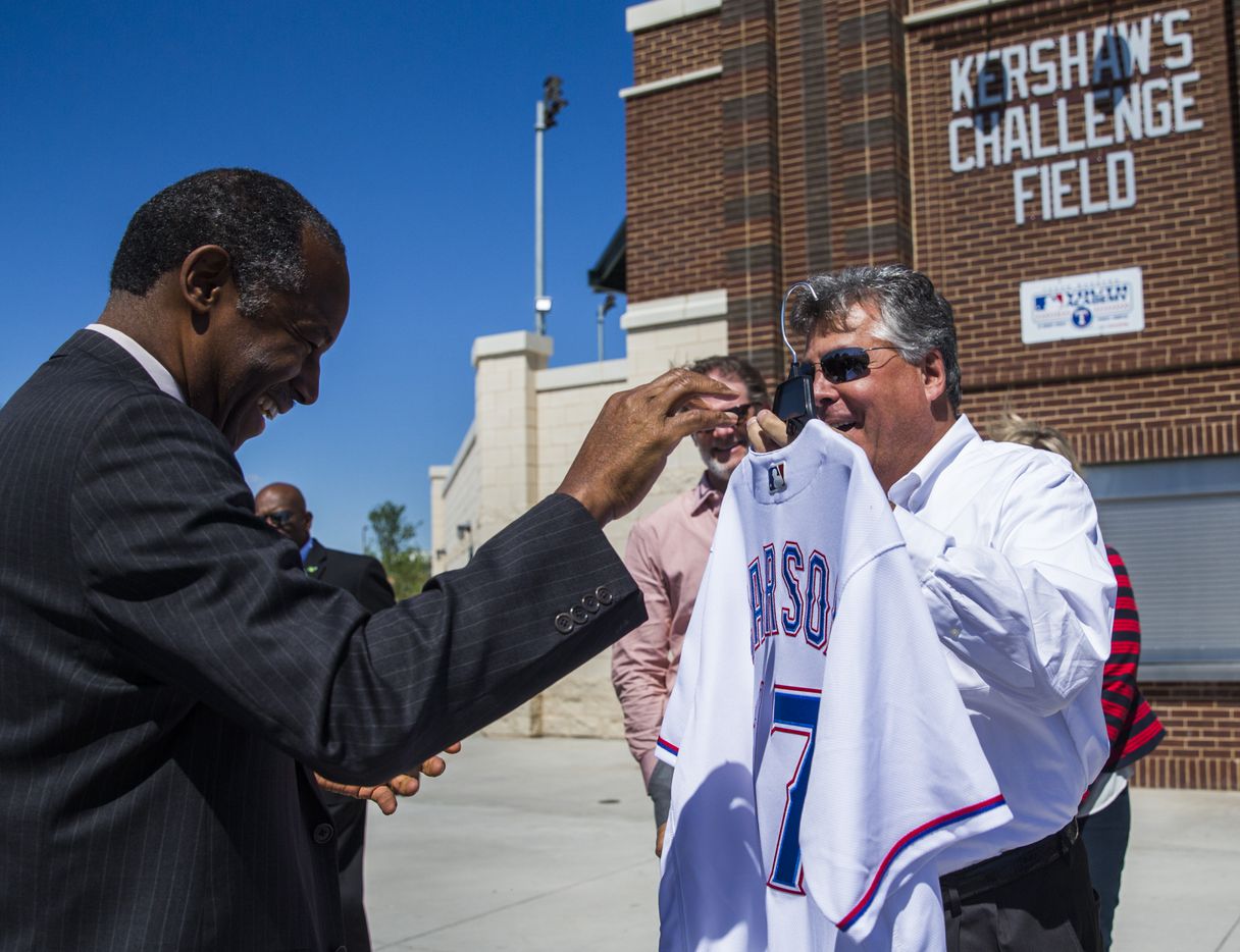 U.S. Secretary of Housing and Urban Development Ben Carson, left, smiles as he is presented...