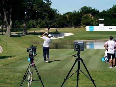 With no fans around the 13th tee box, PGA Tour golfer David Frost watches his shot across...