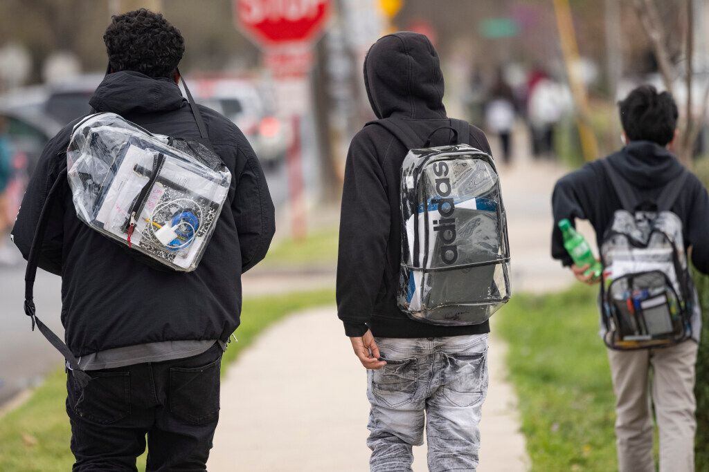 A group of J. L. Long Middle School students wear clear backpacks.