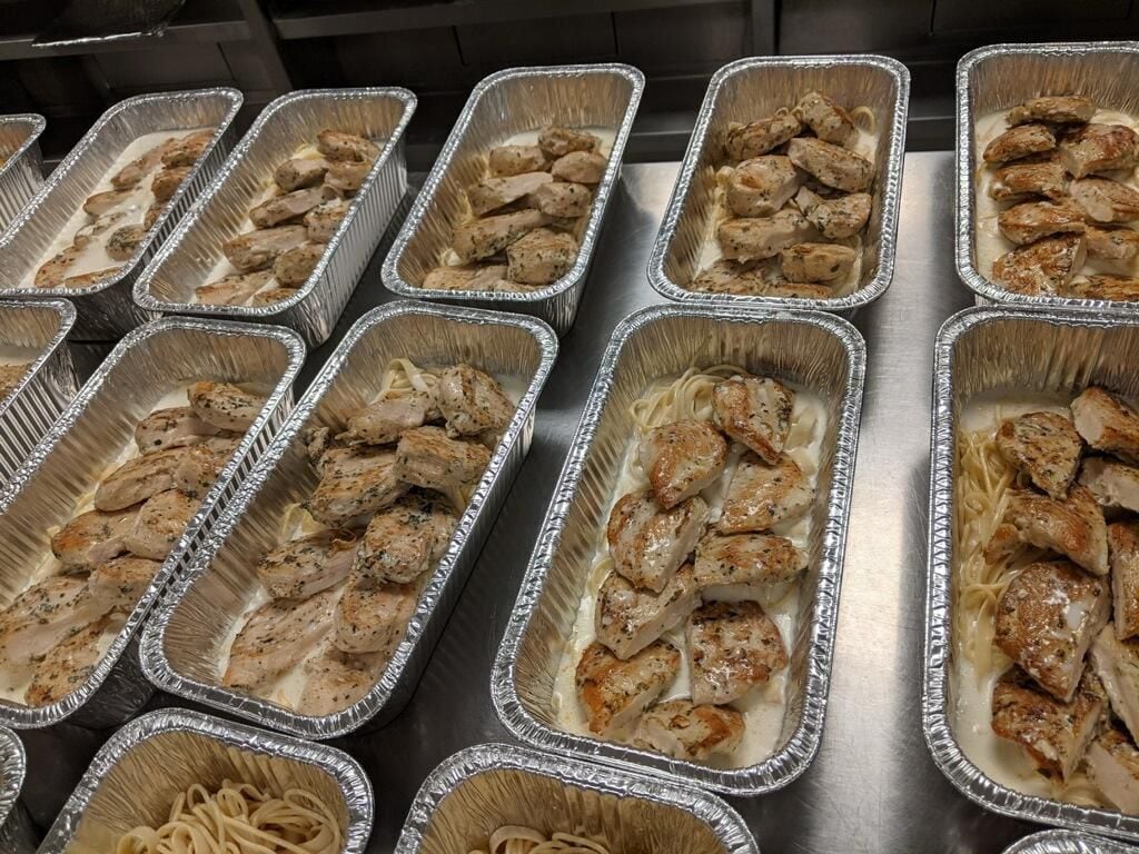 Volunteers in Irving passed out hundreds of meal kits, including chicken piccata and pasta,...
