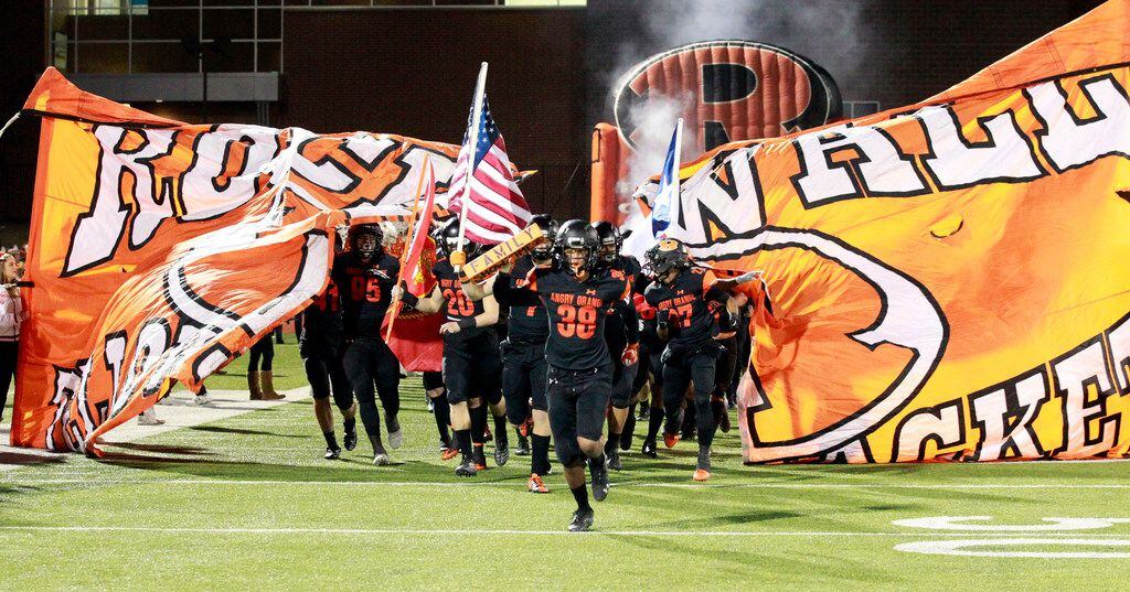The Rockwall team breaks through their banner, as they take the field before the first half...