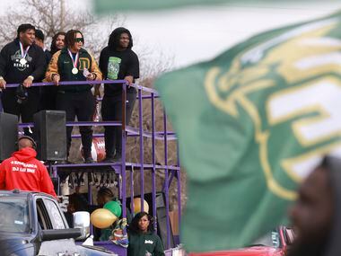 DeSoto High School football players ride on top of a double-decker trailer, Saturday, Jan....