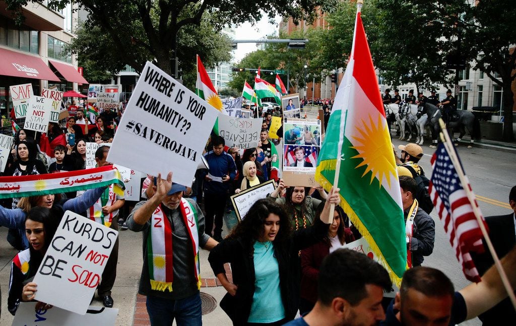 Protesters against the pulling of troops in Syria rally at the site of the Keep America Great Rally for President Donald Trump at the American Airlines Center in Dallas, on Thursday, October 17, 2019.