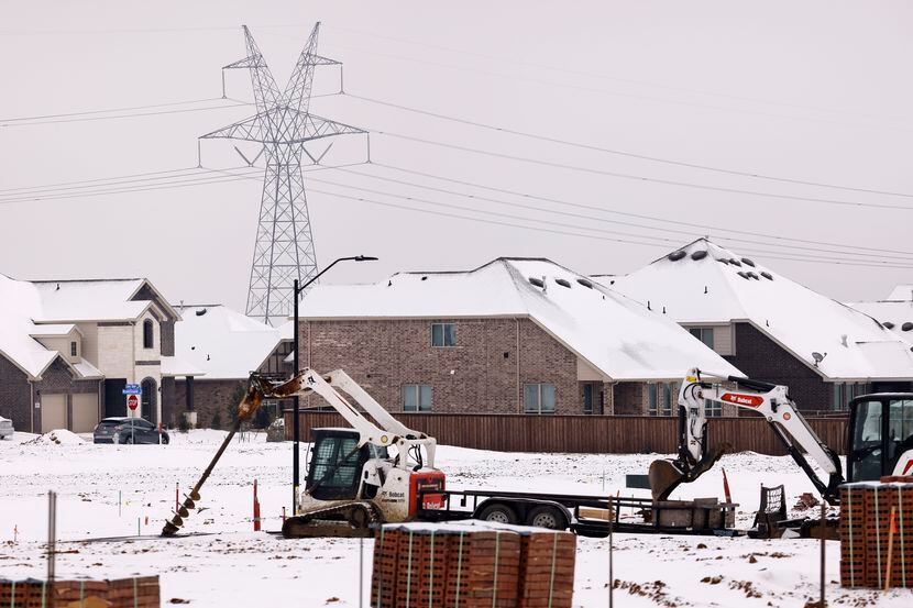Large electrical transmission lines are pictured in a new housing development in South...
