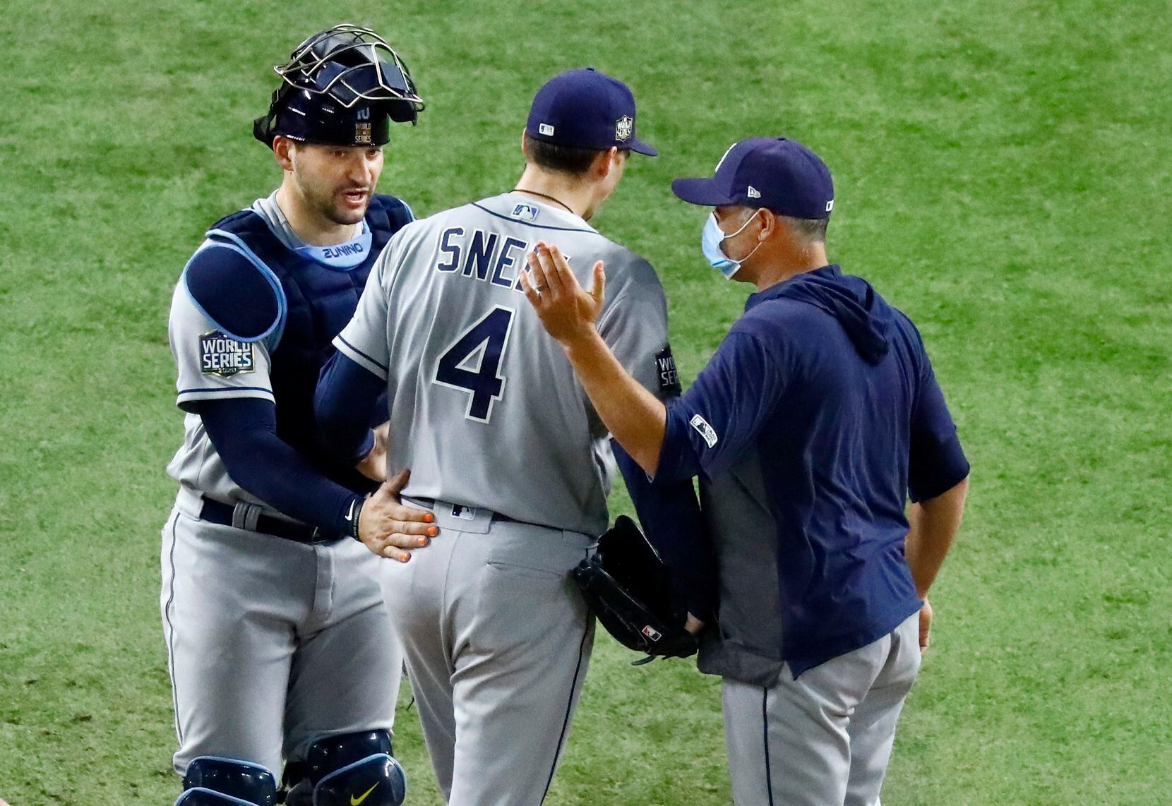 Tampa Bay Rays starting pitcher Blake Snell (4) receives a pat on the back by catcher Mike...