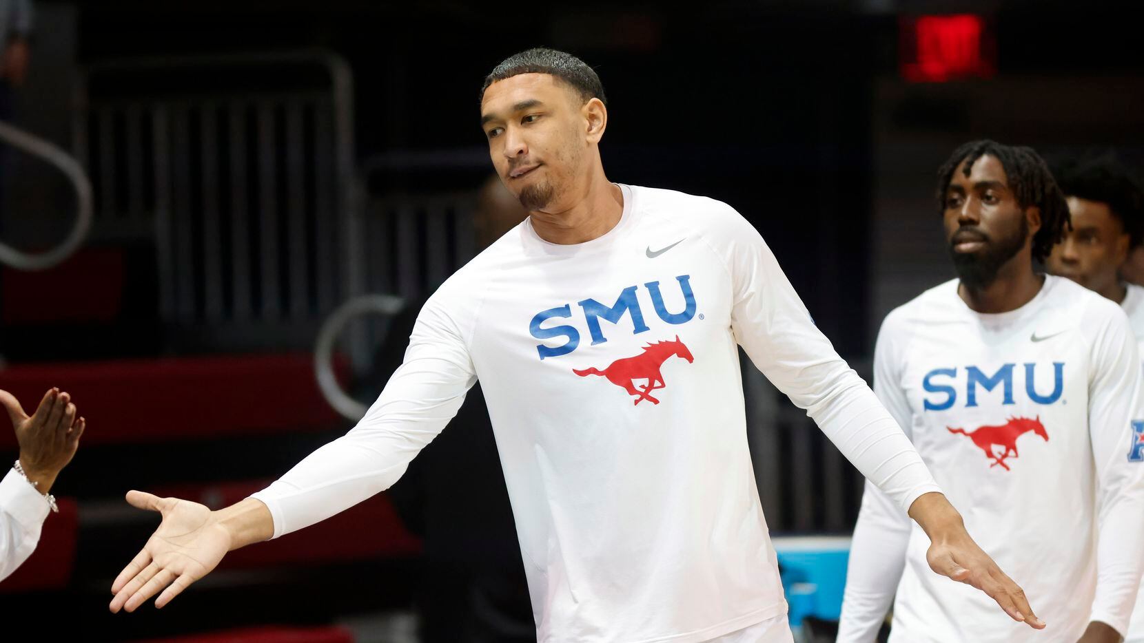 Southern Methodist Mustangs forward Tristan Clark (25) receives a hand slap from fans...