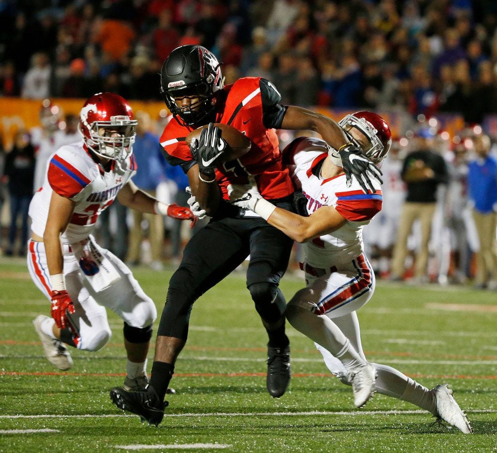 Colleyville Heritage receiver Ke'von Ahmad (1) tires to get past  Grapevine defender Cameron Hamway (21) during their high school football game in Grapevine, Texas, on October 27, 2017. (Michael Ainsworth/Special Contributor) 

