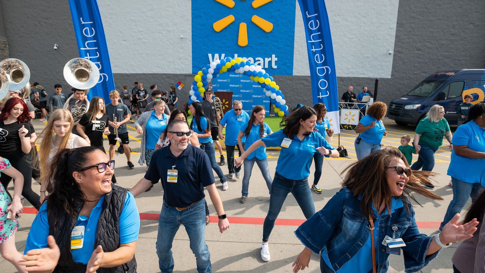 Walmart store managers Marilu Diaz, bottom left, Paul Strunc, center, and human resource...
