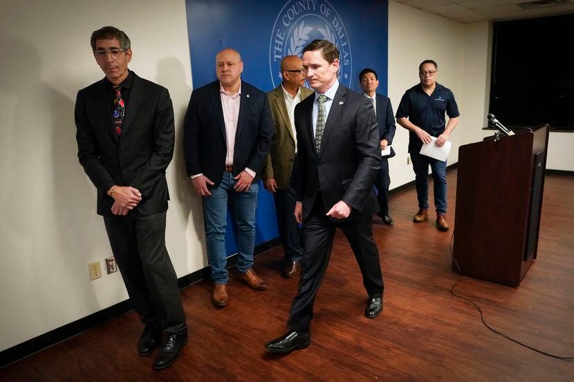 Dallas County Judge Clay Jenkins (center) departed a news conference with other city and...