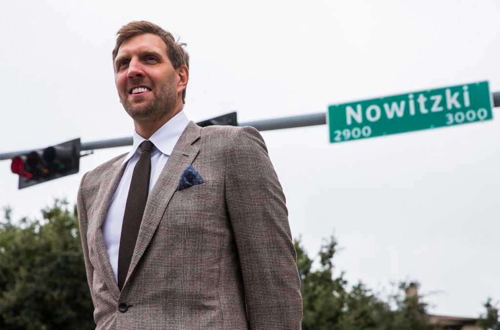 Retired Dallas Mavericks player Dirk Nowitzki poses for photos after unveiling a street sign...