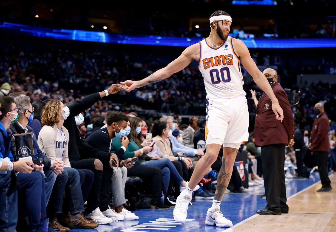 Phoenix Suns center JaVale McGee (00) shakes hands with fans on the sideline during a first...