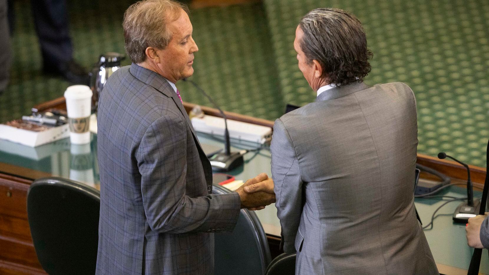 (From left) Texas Attorney General Ken Paxton shakes attorney Tony Buzbee’s hand after the...