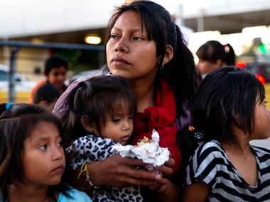 Patricia Giron (center) holds her daughters, Yesenia (left), 6, Wendy (center), 1, and Yocelyn, 6, at the temporary tent camp of asylum-seekers in Matamoros, Mexico, on Saturday, Dec. 14, 2019. The Giron family, from Chiapas, Mexico, is living in temporary tent shelters under the Migrant Protection Policy, which requires asylum-seekers to wait in Mexico while their asylum claims are processed. (Lynda M. Gonzalez/The Dallas Morning News) ORG XMIT: 20048406A
