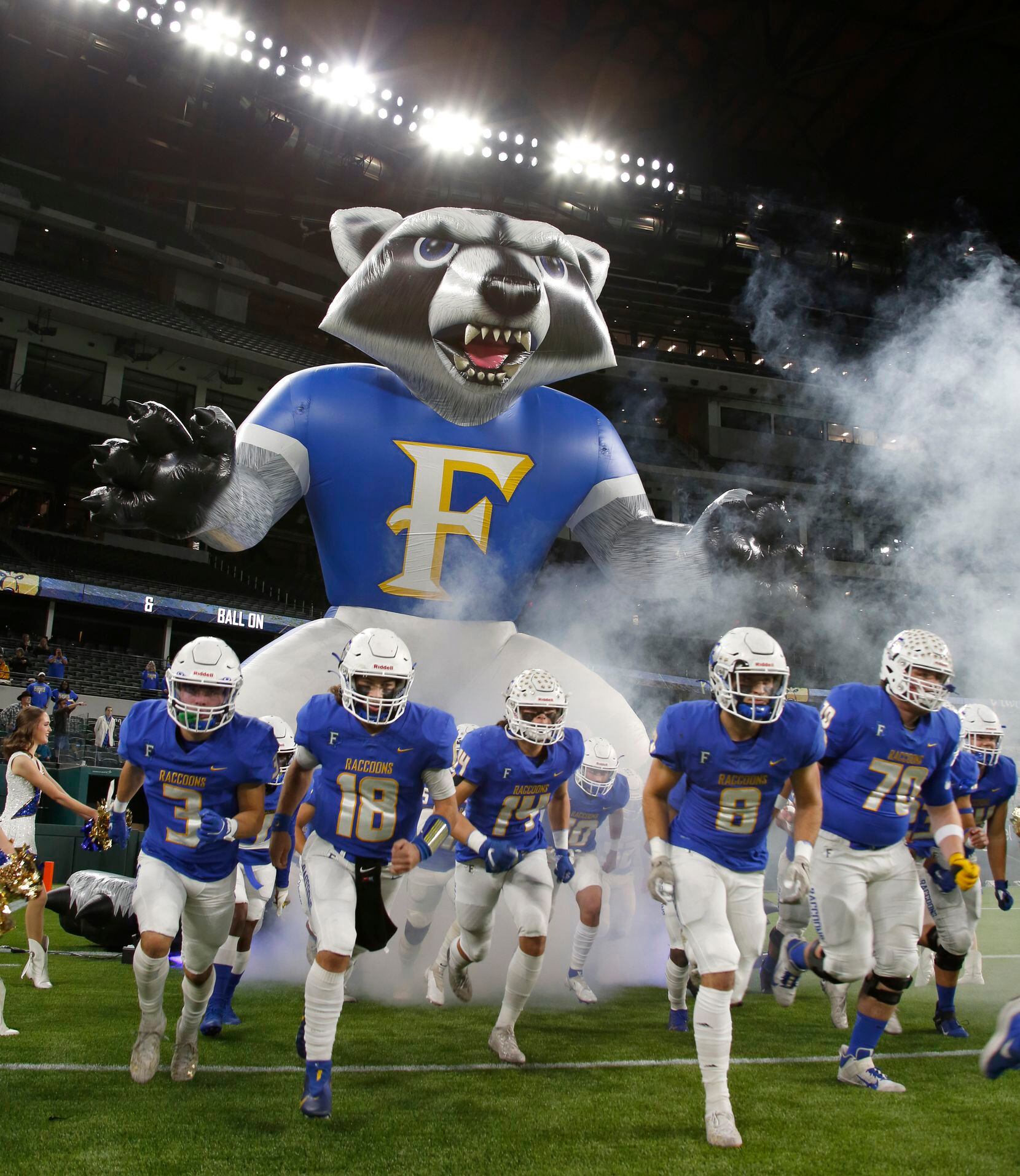 Frisco players run onto the field from their mascot inflatable before the start of their...