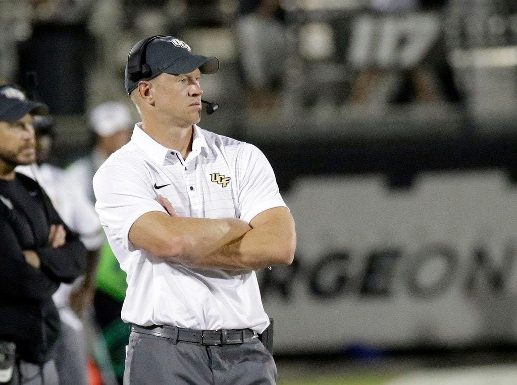 FILE - In this Aug. 31, 2017, file photo, Central Florida head coach Scott Frost watches his...