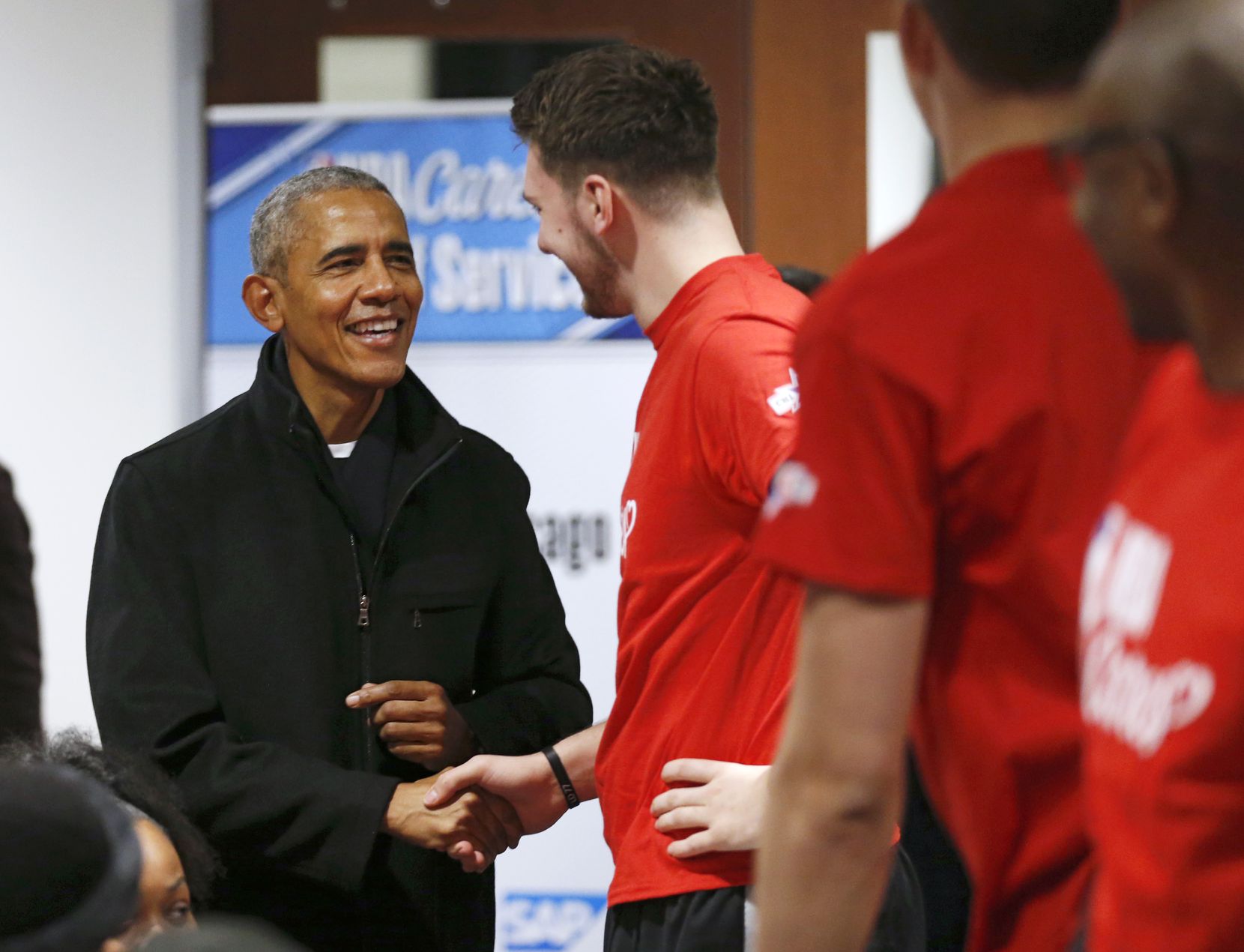 Former President Barack Obama greets Dallas Mavericks forward Luka Doncic (77) during a NBA...